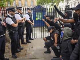 People kneel in front of police during a Black Lives Matter protest in London in June 2020 (Picture: Justin Setterfield/Getty Images)