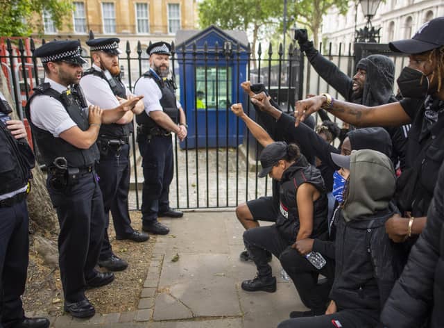 People kneel in front of police during a Black Lives Matter protest in London in June 2020 (Picture: Justin Setterfield/Getty Images)