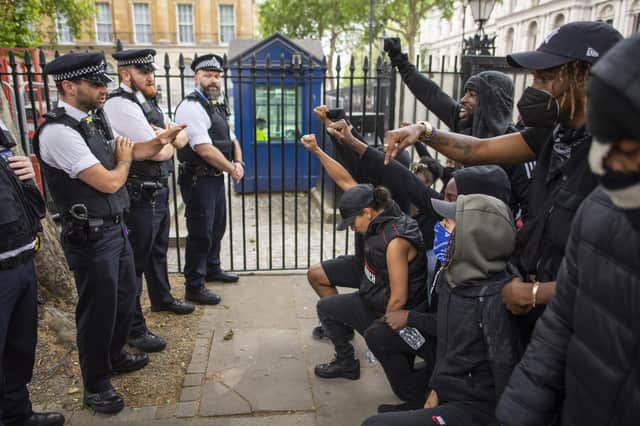 People kneel in front of police during a Black Lives Matter protest in London in June 2020 (Picture: Justin Setterfield/Getty Images)