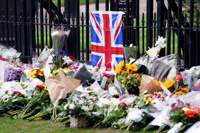 Flowers are laid outside of Windsor Castle, Berkshire, following the death of Queen Elizabeth II on Thursday. Picture date: Friday September 9, 2022.