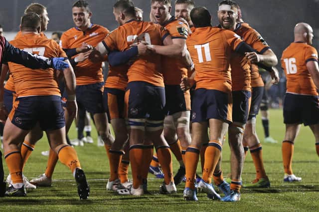 Edinburgh players celebrate on the final whistle at Saracens.