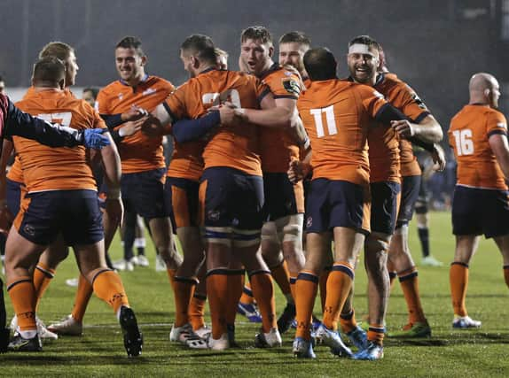 Edinburgh players celebrate on the final whistle at Saracens.