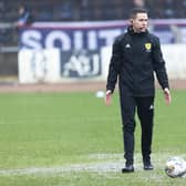 Referee David Munro conducts a pitch inspection prior to calling off the match between Dundee and Aberdeen at Dens Park. (Photo by Mark Scates / SNS Group)