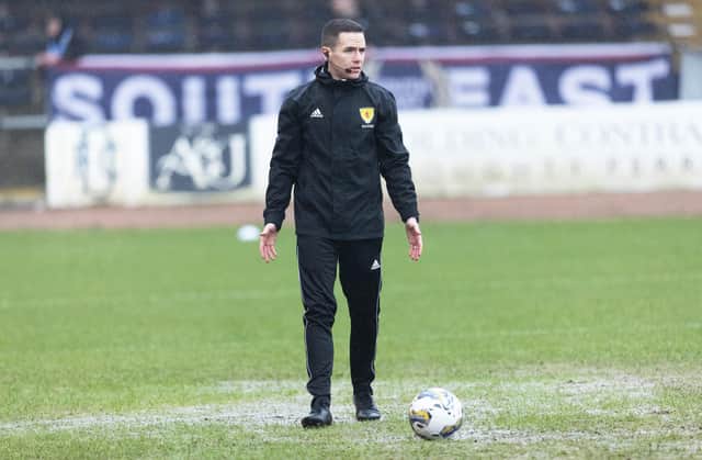 Referee David Munro conducts a pitch inspection prior to calling off the match between Dundee and Aberdeen at Dens Park. (Photo by Mark Scates / SNS Group)
