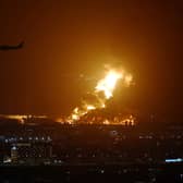 An Aramco oil depot close to the circuit is seen in flames following an incident during practice ahead of the F1 Grand Prix of Saudi Arabia at the Jeddah Corniche Circuit on March 25, 2022 in Jeddah, Saudi Arabia. (Photo by Lars Baron/Getty Images)