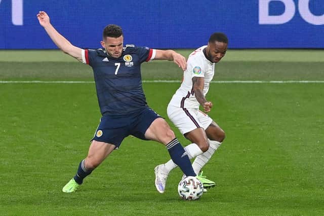 Raheem Sterling battles John McGinn. (Photo by FACUNDO ARRIZABALAGA/POOL/AFP via Getty Images)