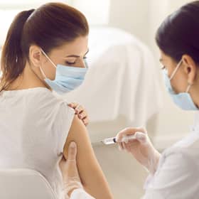 A young woman receives a Covid-19 jab at a new modern vaccination centre