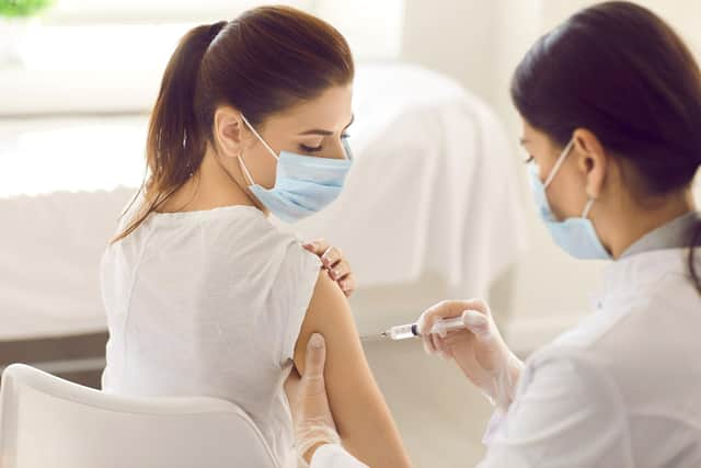 A young woman receives a Covid-19 jab at a new modern vaccination centre