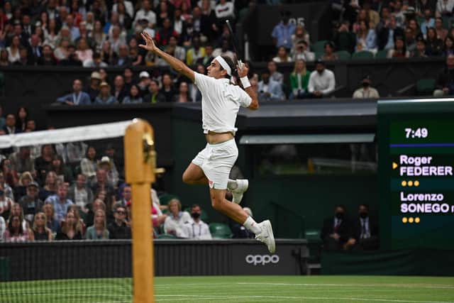 Switzerland's Roger Federer jumps to play a return against Italy's Lorenzo Sonego during their men's singles fourth round match on the seventh day of the 2021 Wimbledon Championships. (Photo by GLYN KIRK/AFP via Getty Images)