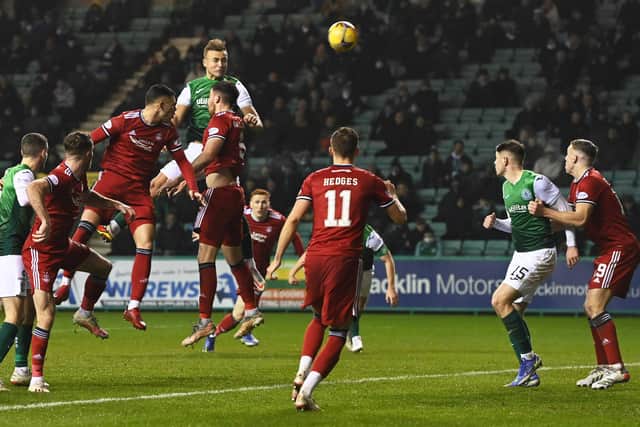 Ryan Porteous scores a header to put Hibs 1-0 up on Aberdeen. (Photo by Ross Parker / SNS Group)