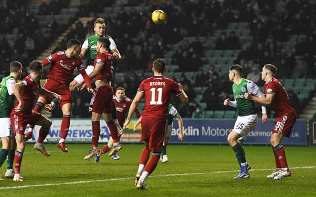 Ryan Porteous scores a header to put Hibs 1-0 up on Aberdeen. (Photo by Ross Parker / SNS Group)