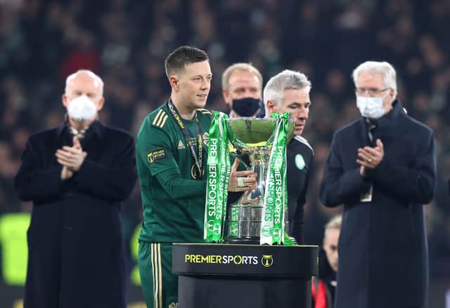 Celtic's Callum McGregor lifts the trophy from the podium after winning the Premier Sports Cup Final at Hampden Park, Glasgow. (Jeff Holmes/PA Wire).