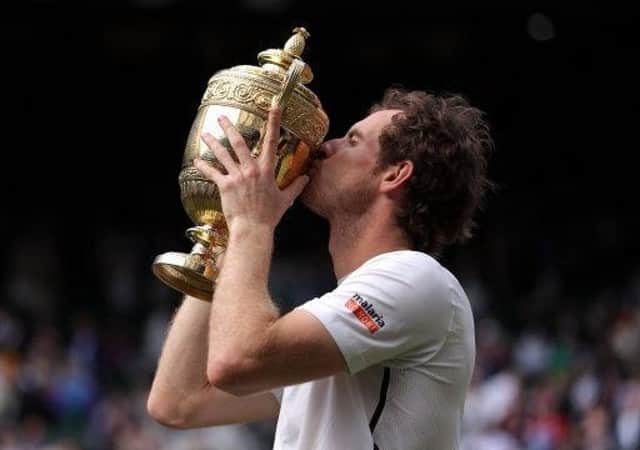 Andy Murray celebrates winning the Men's Singles Final on day thirteen of the Wimbledon Championships at the All England Lawn Tennis and Croquet Club, Wimbledon.