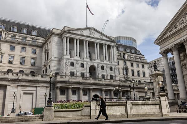 Members of the public walk past the Bank of England in a window as a 0.25 per cent hike in interest rates was announced. Picture: Dan Kitwood/Getty Images