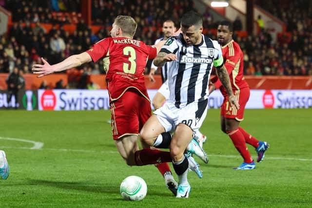 Aberdeen's Jack MacKenzie collides with PAOK's Vieirinha - the Dons wanted a penalty.