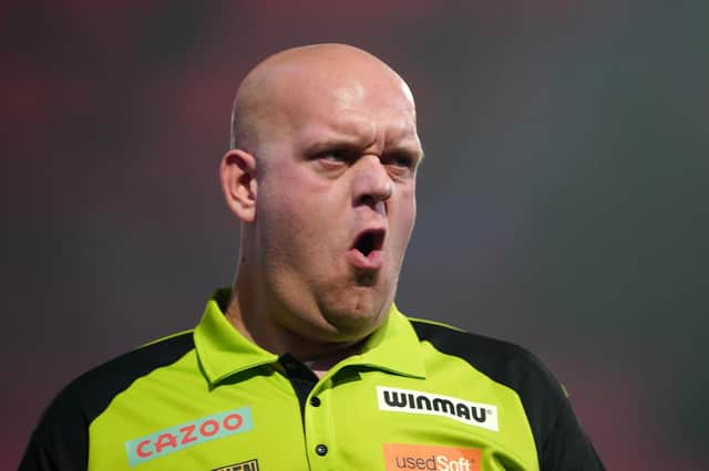 Michael van Gerwen in action against Dimitri Van den Bergh during day fifteen of the Cazoo World Darts Championship at Alexandra Palace, London. Zac Goodwin/PA Wire.