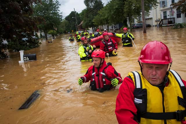 Volunteer firefighters perform a search after a flash flood hit Helmetta, New Jersey, as Tropical Storm Henri made landfall. Warmer air holds more moisture, making such flooding more likely (Picture: Tom Brenner/AFP via Getty Images)