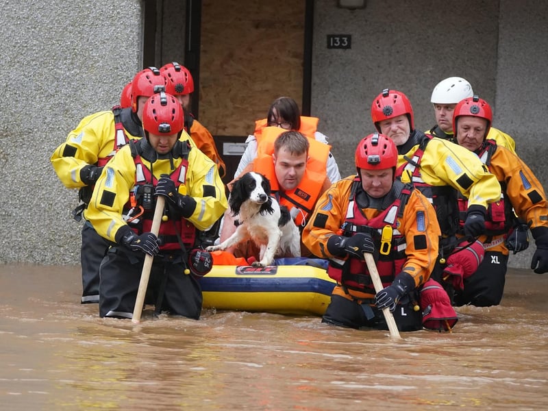 Members of the emergency services help local residents to safety in Brechin, Scotland, as Storm Babet batters the country.