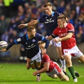 Finn Russell of Scotland passes the ball out the back of his hand during the Six Nations Rugby match between Scotland and Wales at Murrayfield Stadium.
