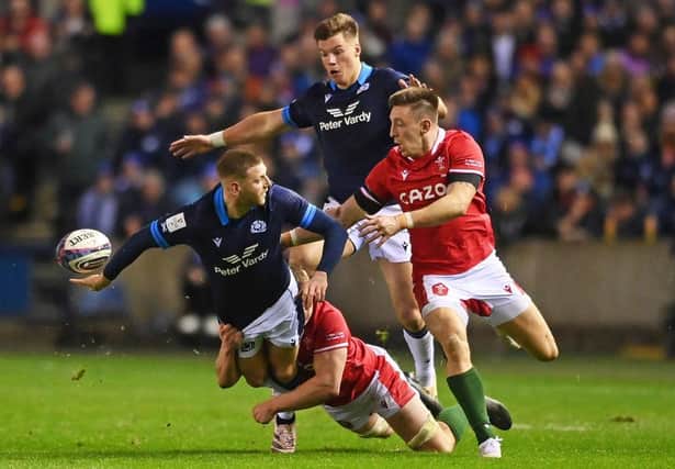 Finn Russell of Scotland passes the ball out the back of his hand during the Six Nations Rugby match between Scotland and Wales at Murrayfield Stadium.