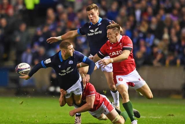 Finn Russell of Scotland passes the ball out the back of his hand during the Six Nations Rugby match between Scotland and Wales at Murrayfield Stadium.