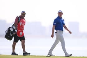 Grant Forrest and his caddie Davy Kenny walk on the 18th green during day three of the Abu Dhabi HSBC Championship at Yas Links. Picture: Ross Kinnaird/Getty Images.