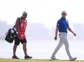 Grant Forrest and his caddie Davy Kenny walk on the 18th green during day three of the Abu Dhabi HSBC Championship at Yas Links. Picture: Ross Kinnaird/Getty Images.