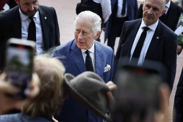 King Charles III greets supporters during an impromptu walkabout on the Mall