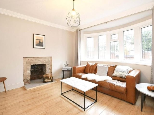 Almost certainly the most relaxing room in the Clipstone Avenue house is this sitting room. Note the characterful feature fireplace, and the impressive, big bay windows that overlook the front of the property.