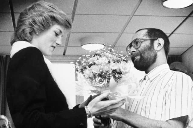 Princess Diana is presented with a bouquet by Aids patient Martin Johnson during a visit to the Mildmay Mission Hospital Aids Hospice in East London in 1989 (Picture: PA)