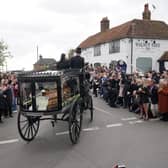 The funeral cortege of Paul O'Grady travels through the village of Aldington, Kent ahead of his funeral at St Rumwold's Church. Picture: Yui Mok/PA Wire