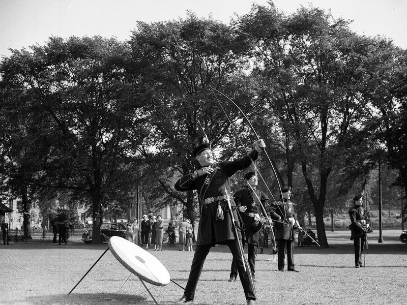 Brigadier J. Grainger Stewart, of the Royal Company of Archers, prepares to take aim.