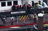 Migrants are escorted ashore from the UK Border Force vessel 'BF Ranger' in Dover earlier this year after having been picked up at sea while attempting to cross the English Channel.