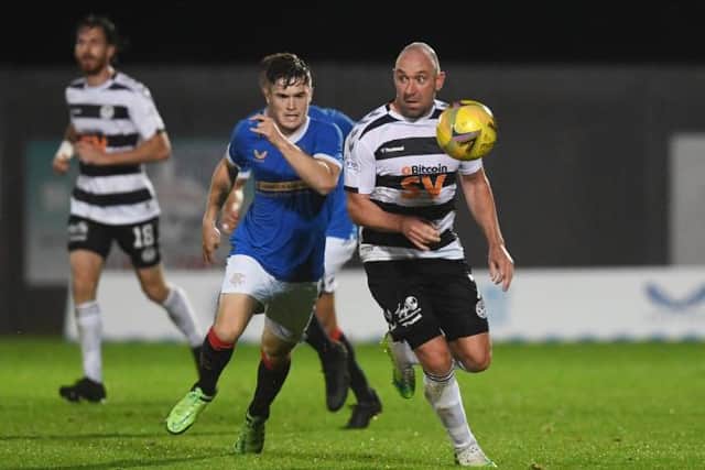 Ayr United's Michael Moffat (right) competes with Robbe Ure during an SPFL Trust Trophy match between Rangers B and Ay United at the C&G Systems Stadium on September 14, 2021, in Dumbarton, Scotland.  (Photo by Craig Foy / SNS Group)