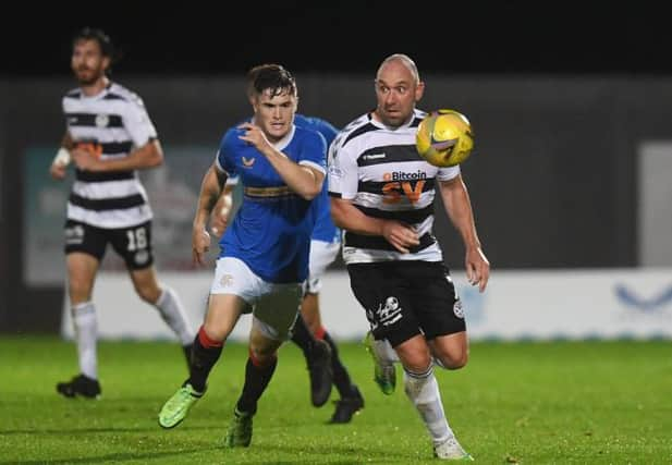 Ayr United's Michael Moffat (right) competes with Robbe Ure during an SPFL Trust Trophy match between Rangers B and Ay United at the C&G Systems Stadium on September 14, 2021, in Dumbarton, Scotland.  (Photo by Craig Foy / SNS Group)