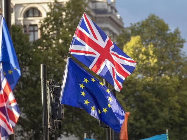 A Union flag and EU flag outside the Houses of Parliament. PIC: Steve Parsons/PA Wire