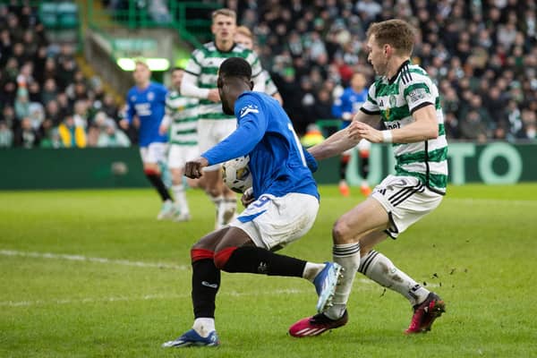 Rangers claim for a penalty after the ball hits the arm of Celtic's Alistair Johnston.