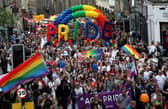 Pride marchers march up the Royal Mile in Edinburgh.