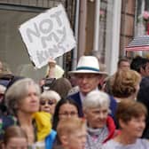 A protester holds up a "Not My King" placard in the crowd as people wait to greet Britain's King Charles III and Britain's Queen Camilla. Picture: Andrew Milligan/AFP via Getty Images
