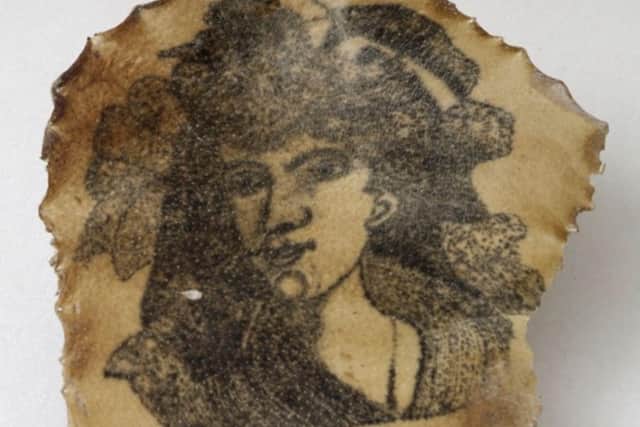 A 19th Century tattoo on a piece of human skin showing a female face.  PIC: Wellcome Collection.