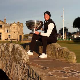 Danny Willett poses with the trophy on the Swilcan Bridge at St Andrews after winning the 20th Alfred Dunhill Links Championship. Picture:  Matthew Lewis/Getty Images.