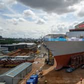 The forward section of Type 26 Frigate HMS Cardiff is rolled out at BAE Systems Shipyard in Govan