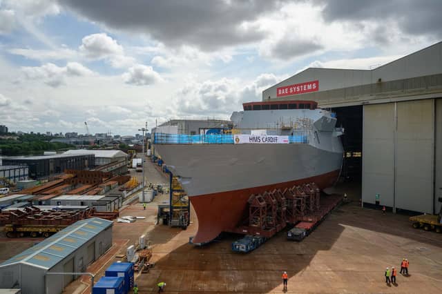 The forward section of Type 26 Frigate HMS Cardiff is rolled out at BAE Systems Shipyard in Govan