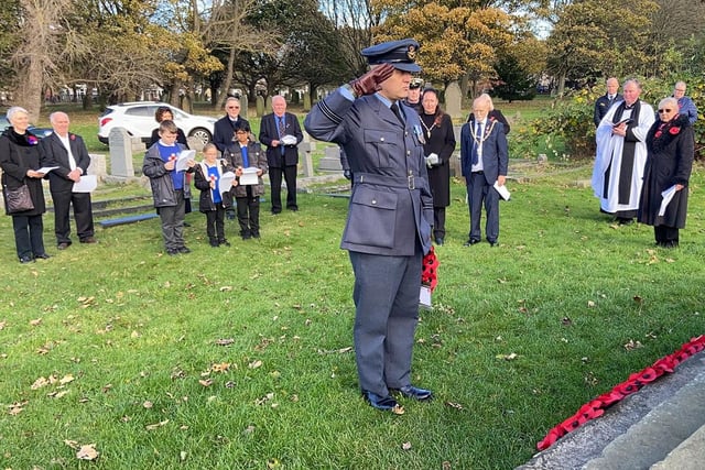 A representative from the Royal Air Force salutes before he lays his wreath.