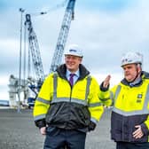 Alex Fyfe, managing director of OM Heavy Lift, and David Webster, director of energy at Forth Ports on site in the Port of Dundee with OMHL’s heavy lift cranes in the background. Picture: Peter Devlin