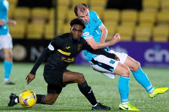 Paul McGowan and Livingston's Stephane Omeonga jostle for the ball in midfield as Dundee fell 2--0 to their hosts (Photo by Mark Scates / SNS Group)