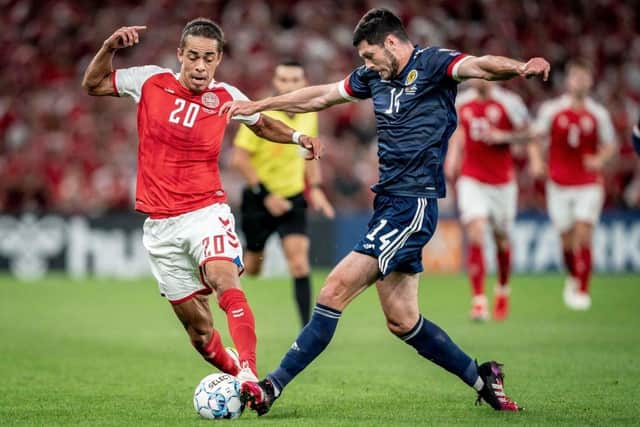 Scotland's defender Scott McKenna (R) fights for the ball with Denmark's forward Yussuf Yurary Poulsen in Copenhagen on September 1, 2021. (Photo by MADS CLAUS RASMUSSEN/Ritzau Scanpix/AFP via Getty Images)