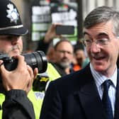 Jacob Rees-Mogg ) looks at a photographer as he arrives to attend the opening day of the annual Conservative Party Conference in Birmingham