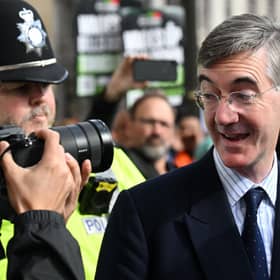 Jacob Rees-Mogg ) looks at a photographer as he arrives to attend the opening day of the annual Conservative Party Conference in Birmingham