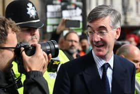 Jacob Rees-Mogg ) looks at a photographer as he arrives to attend the opening day of the annual Conservative Party Conference in Birmingham